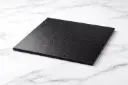 Black cake drum on marble surface.webp