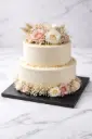 Elegant floral adorned buttercream cake.webp